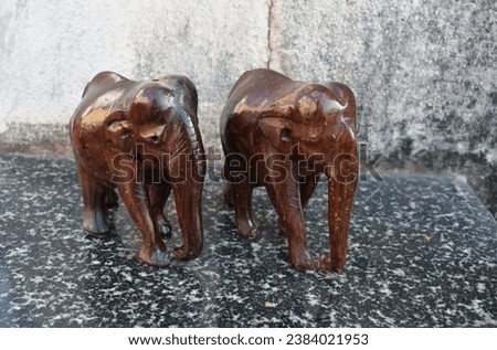 A closeup picture of a carved wooden elephant sculpture.