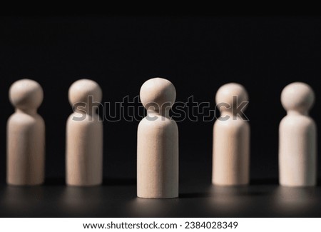 Wooden stock blocks stacked and copy space, black background, business leader concept.