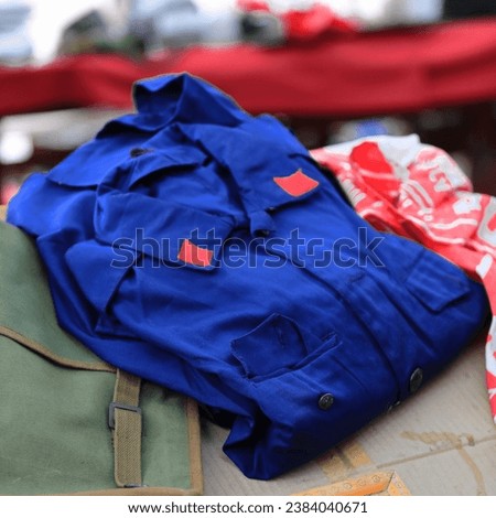Vintage Albanian voluntary military forces blue uniform shirt and green canvas haversack from c.1981 in the ranks abolished, pro-Chinese communist period, Pazari i Ri-New Bazaar. Tirana-Albania Royalty-Free Stock Photo #2384040671