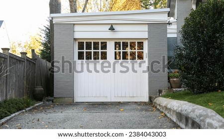 garage door of a charming home exudes nostalgia, urban character, and resilience under changing seasons, making it a timeless architectural element