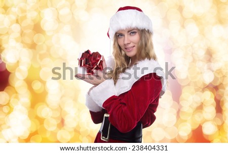 Beautiful young girl in a Christmas costume. New Year's holidays. Woman celebrating Christmas. Holiday gift