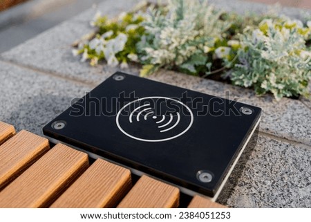 Charging pad for smartphones in the park in summer