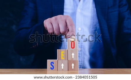 Business SEO or search engine optimization ladder to success concept, Hand arranging wooden blocks, Search engine optimization concept with words SEO.
