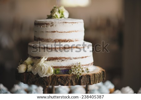 wedding cake on the wooden plate Royalty-Free Stock Photo #238405387