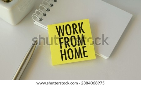 Work From Home text on a notebook near pen and yellow sticker