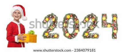 Boy Santa Claus is holding a christmas gift and 2024 number made by christmas tree branches isolated on white background