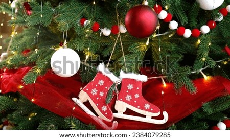 New Year background, Christmas tree with wooden toys. Decorations on a Christmas tree with a garland, close-up. The Christmas tree is decorated with toys and garlands. New Year celebration concept.