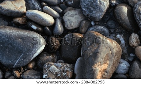 Graphical screensaver capturing the essence of the seashore with its depiction of stones polished by the gentle action of water, creating a serene and natural ambiance.