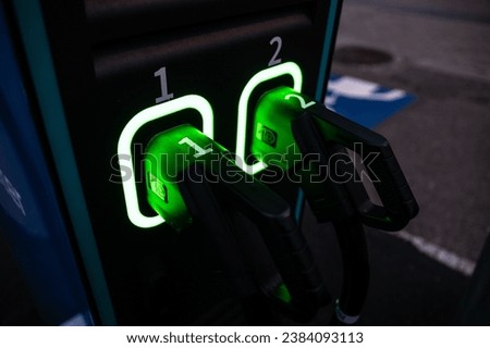 Two charging handles of an electric car charger.