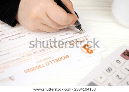 Accountant fill italian tax form Modello 730 individual income tax return in end of tax period. Taxation and paperwork routine in Italy