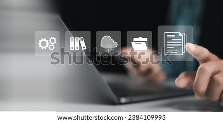 Document management system technology concept, businessman use laptop and touching document online for online documentation database and digital file storage system.