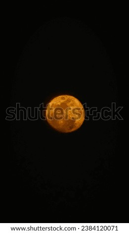 a beautiful close up photo of the moon. full moon. reddish moon at night. bulla texture, isolated by dark background 