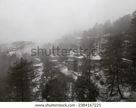 Following a fresh snowfall, the mountains of Murree, Pakistan, transform into a breathtaking, otherworldly landscape. The picture captures a mesmerizing view of these snow-clad peaks.