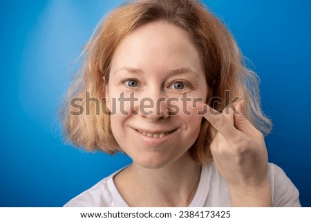 contact eye lenses, a woman holds a lens to her eye for vision correction