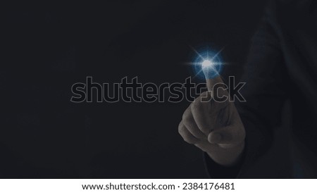 Businessman hand presses a glowing blue light. Concept of command with modern technology.