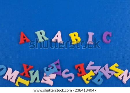 ARABIC word on blue background composed from colorful abc alphabet block wooden letters, copy space for ad text. Learning english concept