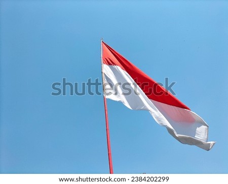 Indonesia national flag with red and white in sky. Close-up.