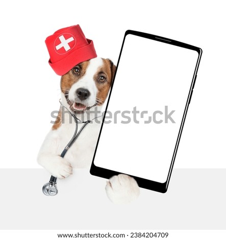 Smart jack russell terrier wearing like a doctor with stethoscope on his neck showing big smartphone with white blank screen in it paw above empty white banner. isolated on white background