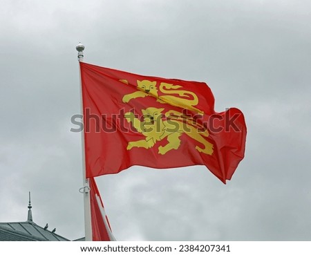 Red and Yellow Flag and coat of arms of Normandy  with two lions Royalty-Free Stock Photo #2384207341