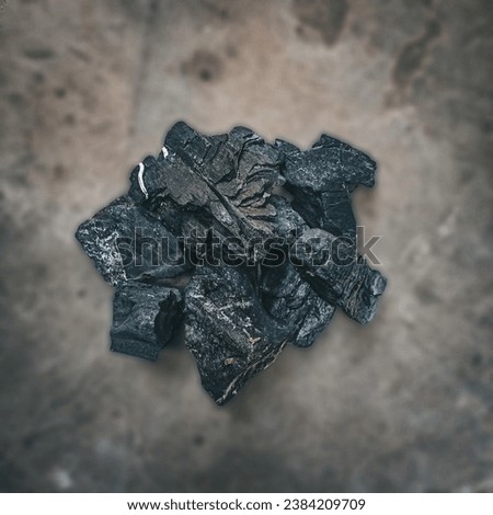 A pile of wet charcoal exposed to rainwater in the morning.