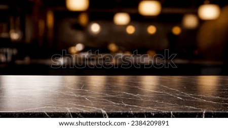 Black marble bar counter top with blank space product mockup. on dark blurred background of restaurant or bar. Blurred lights in background. product placement Royalty-Free Stock Photo #2384209891