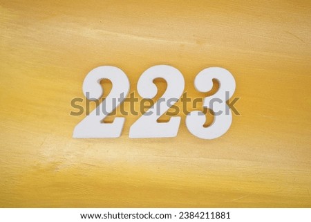 The golden yellow painted wood panel for the background, number 223, is made from white painted wood.