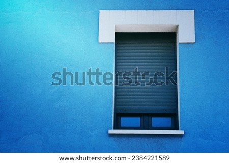 window on the blue facade of the house architecture