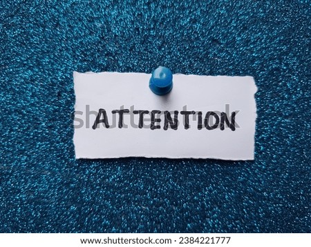 Attention written on a blue background.