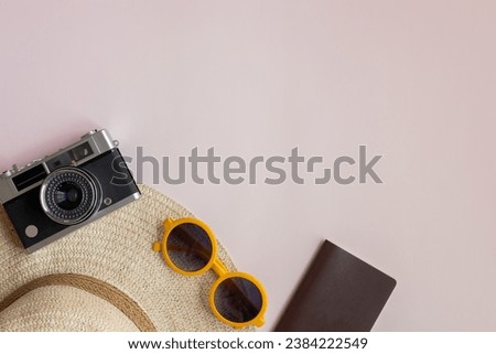 Top view Accessories for travel and camera on pink background with copy space