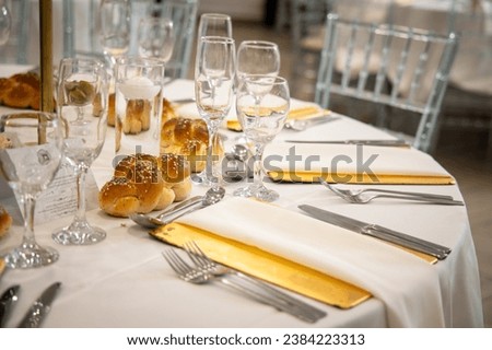 table décor ideas for Jewish orthodox Hasidic wedding, event. Place settings with flowers and cutlery. Kosher food and candles Royalty-Free Stock Photo #2384223313