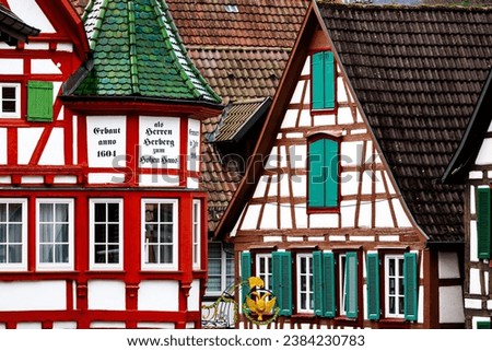 Colorful half-timbered houses in a Black Forest village, Schiltach, Germany (Facade reads „Built anno 1604 as Lords Inn at the High House – Renewed in 2016“) Royalty-Free Stock Photo #2384230783
