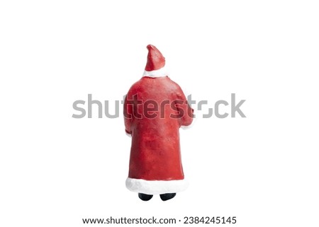 Miniature people Santa Claus holding gift box isolated on white background with clipping path