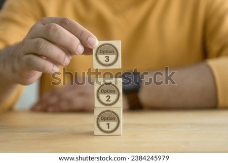 Man choose the right Options plan. Determine you can varying forms, alternative backup plan. Contingency plan in business concept. Hand choosing 3 Options plan in wooden blocks