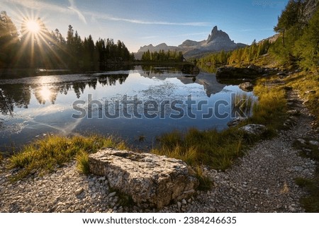 Amazing sunrise on Lago di Federa. Autumn landscape in the morning in the Italian Dolomites with a view of the Croda do Lago peak. Royalty-Free Stock Photo #2384246635