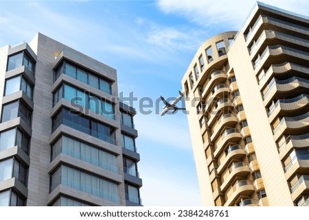 Big passenger plane over house. airplane is flying over building. bottom view Royalty-Free Stock Photo #2384248761