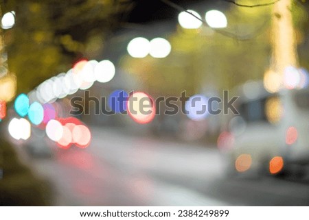 Blurred footage of transport. Blur of city lights along the road, light out of focus at night. Night city traffic, beautiful background.