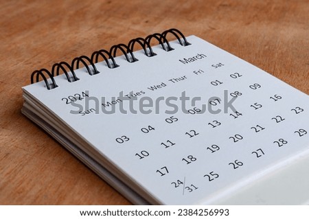 March 2024 white table calendar on wooden background. Calendar concept. Royalty-Free Stock Photo #2384256993
