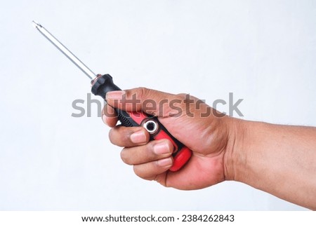 hand holding screwdriver isolated white background