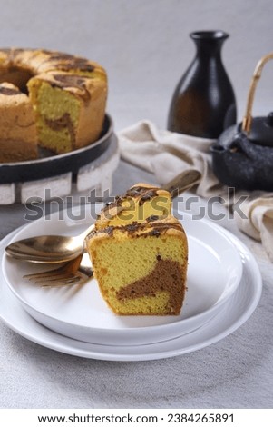 Concept White Background Bakery, Marble Cake Slice on White Plate with Ingredient at Background