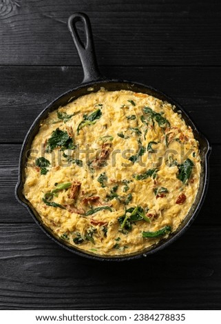 Creamy spaghetti squash pasta with parmesan cheese and sun dried tomato sauce in iron cast pan Royalty-Free Stock Photo #2384278835