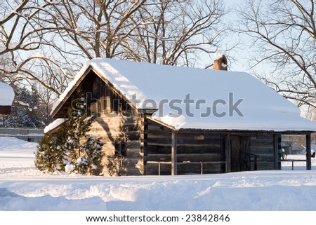 Old wood cabin covered in snow