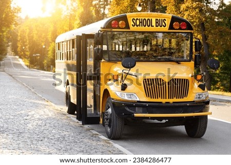 Transportation Services Concept. Front Shot Of Parked Retro Yellow School Bus With Stop Sign Standing On The Road, Empty Schoolbus With Opened Doors Waiting For Pupils On Parking Lot, Copy Space
