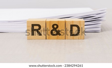 concept word 'R and D - Research and development' on cubes on a white background from office paper. business concept Royalty-Free Stock Photo #2384294261