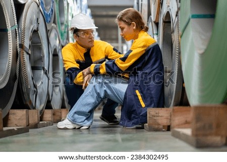 tired female worker feeling sick after stressed work in manufacturing factory, exhausted woman technician has problem working overload, male foreman support consoling and encorage at metal warehouse Royalty-Free Stock Photo #2384302495