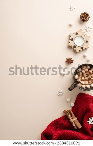 Winter comfort aesthetic: Top-view vertical photo of hot beverage, marshmallows, candle, spices, pine cone, and a red plaid on a soft beige background, ideal for your text or branding