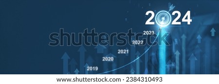 Businessman analyzing financial balance sheet of company working with digital virtual graphics. Businessman is calculating financial data for investment growth target in 2024