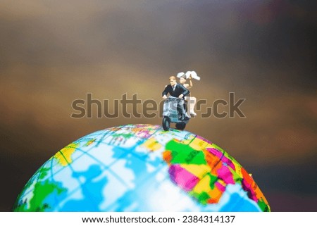 Miniature people : Couple riding the motorcycle on The Globe , Valentines concept