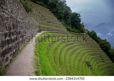 Wiñay Wayna is situated on the Inca Trail, which is the famous hiking route that leads to Machu Picchu. It is located approximately 4 kilometers (2.5 miles) from Machu Picchu. Royalty-Free Stock Photo #2384314705