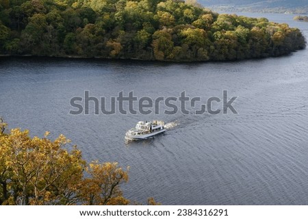 Cruise boat heading to Balmaha at Loch Lomond Royalty-Free Stock Photo #2384316291
