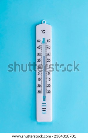 thermometer hanging on a blue background